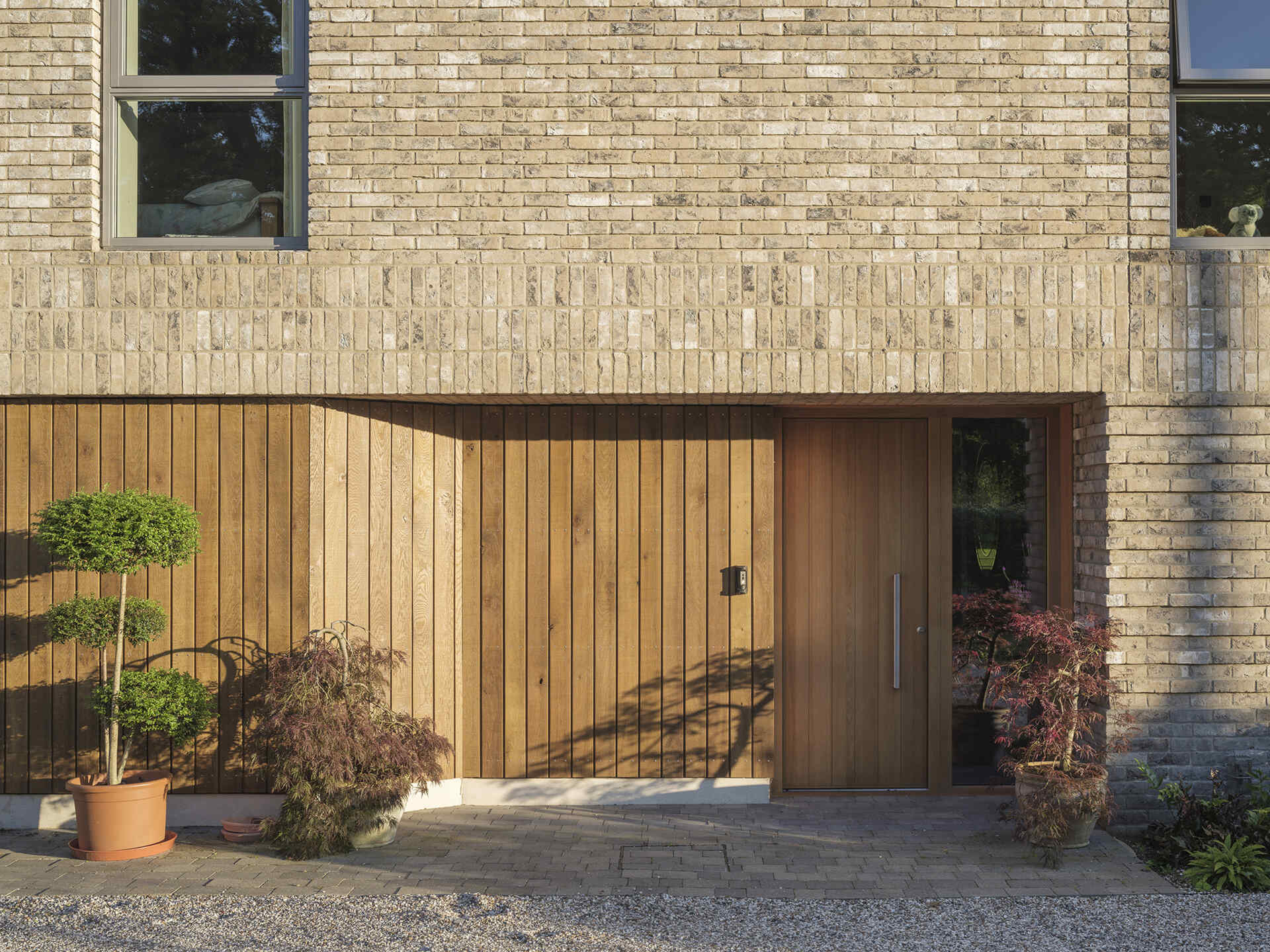 Explore the textured brickwork of this modern Suffolk house, where different brick patterns reference the history of traditional English longhouses.