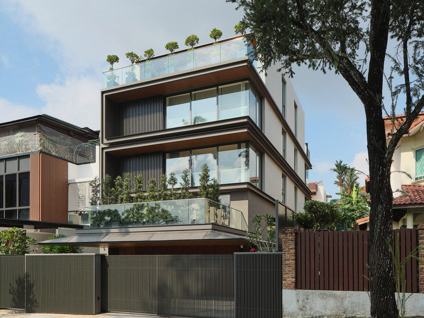 Explore JS-House by ONG&ONG, a contemporary home in Singapore featuring expansive glazing, warm timber interiors, landscaped terraces, and an impressive art collection.
