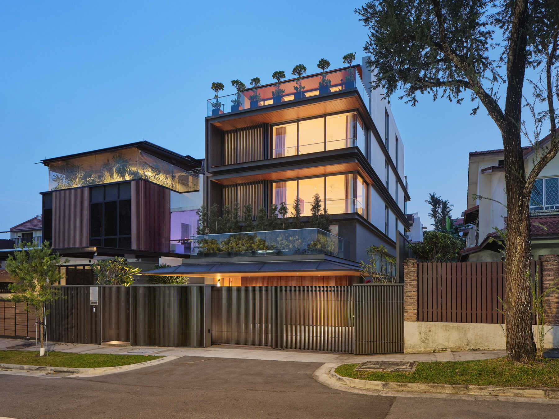 Discover the contemporary architecture of JS-House in Singapore, featuring layered horizontal forms, floor-to-ceiling corner windows, planted terraces, and rooftop greenery.