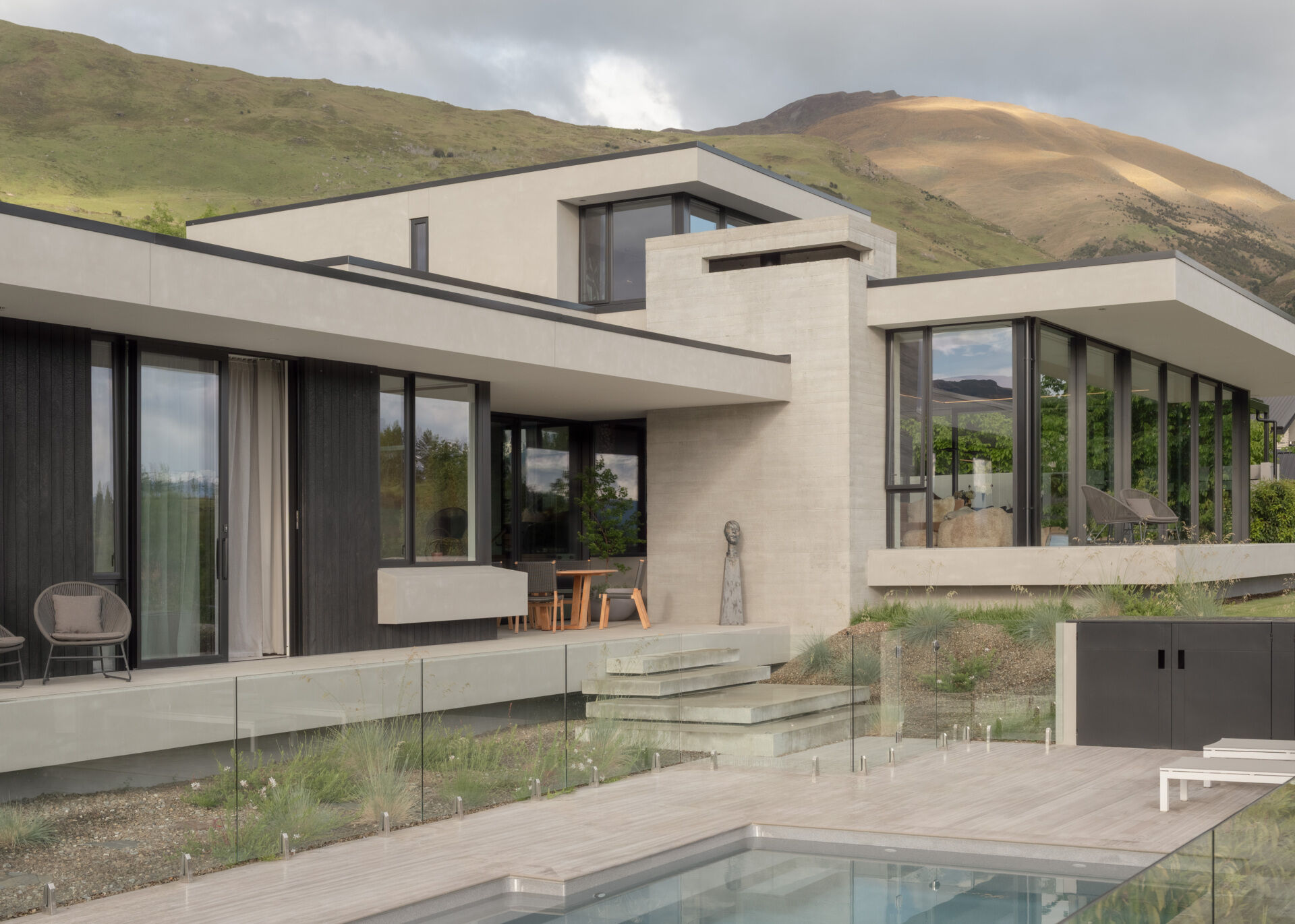 Explore a contemporary W?naka house by Condon Scott Architects, with floating concrete terraces, mountain views, dark oak interiors and a sky-lit dressing room.