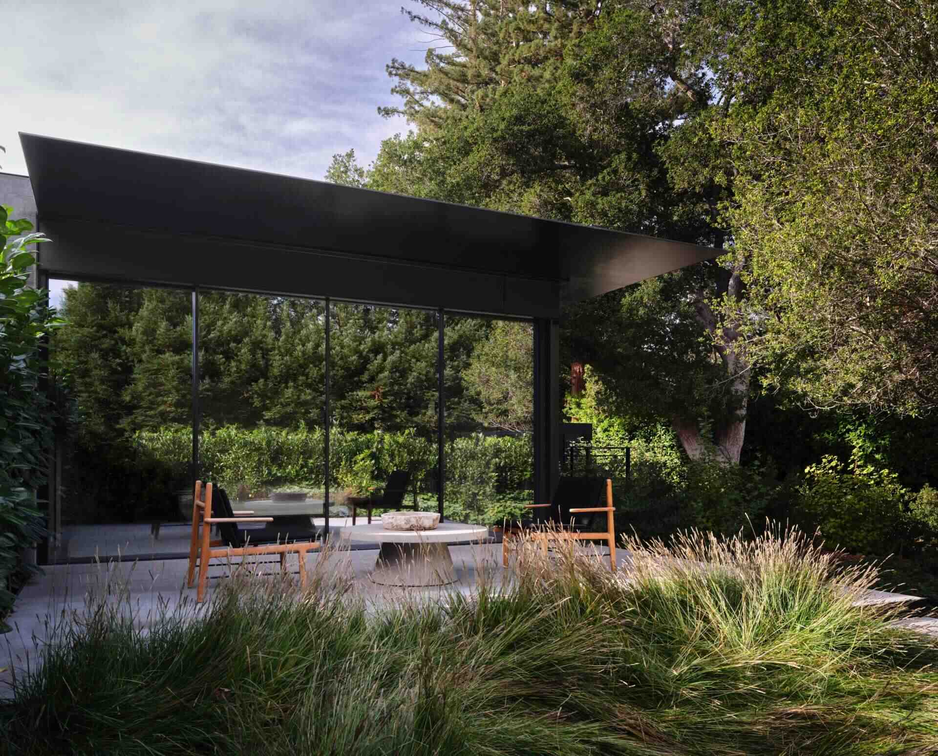 Discover the landscape design of this modern Bay Area home by Andrea Cochran Landscape Architecture. Featuring ornamental grasses, tree-lined gravel pathways, woodland gardens, native planting, and sustainable landscaping ideas across a 3.5-acre California property.