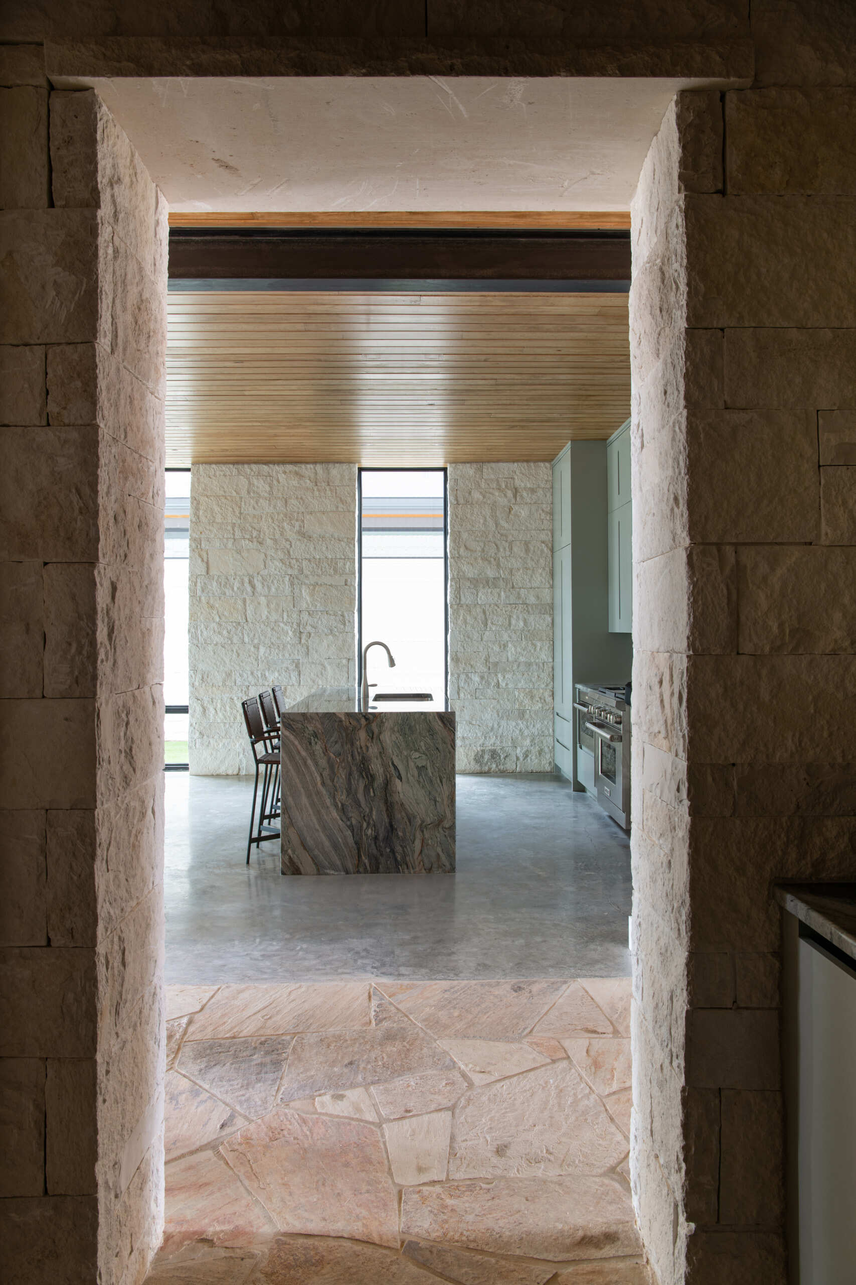 Thick limestone walls and stone-framed doorways give these contemporary Texas homes distinctive entryways and hallways.