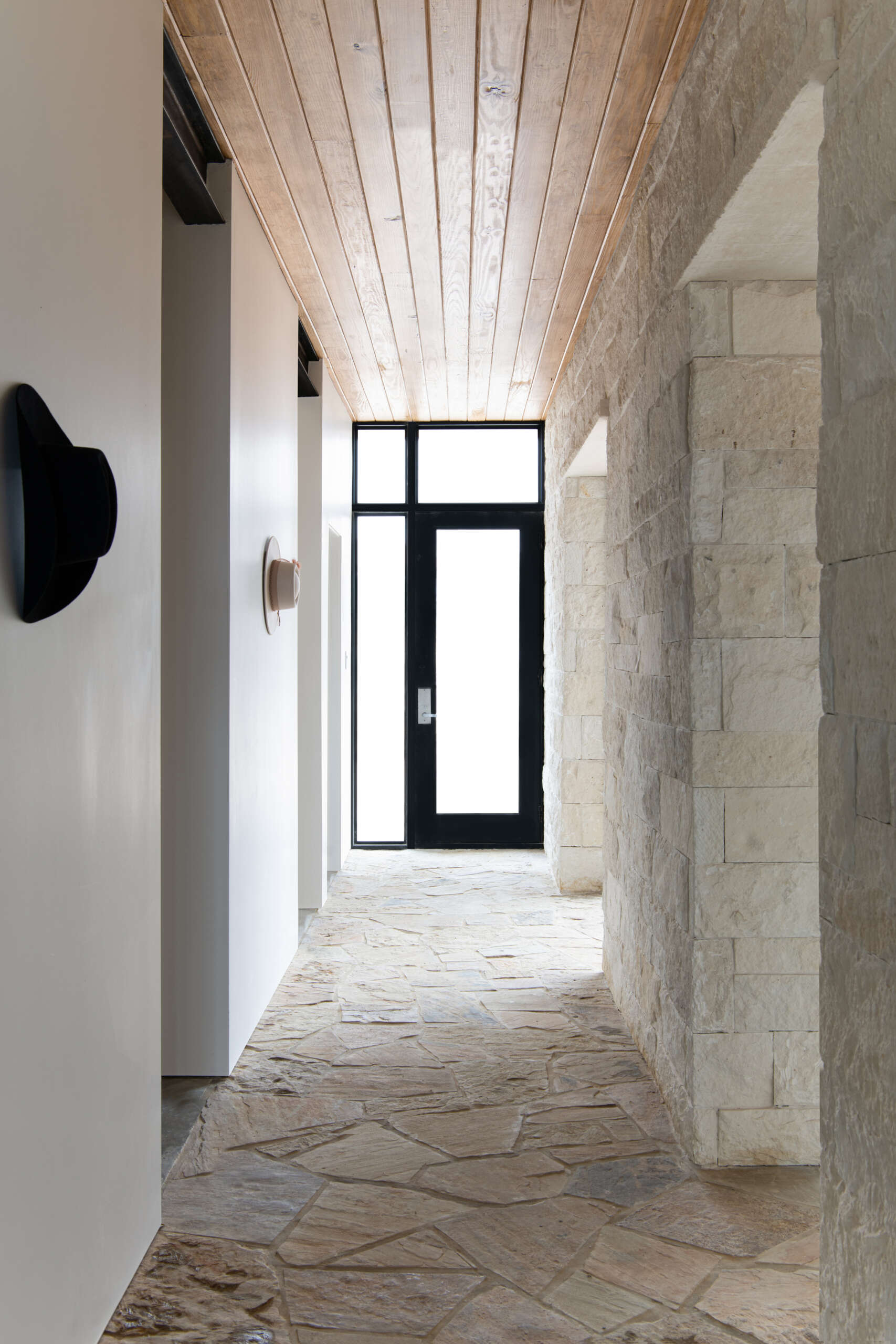 Thick limestone walls and stone-framed doorways give these contemporary Texas homes distinctive entryways and hallways.