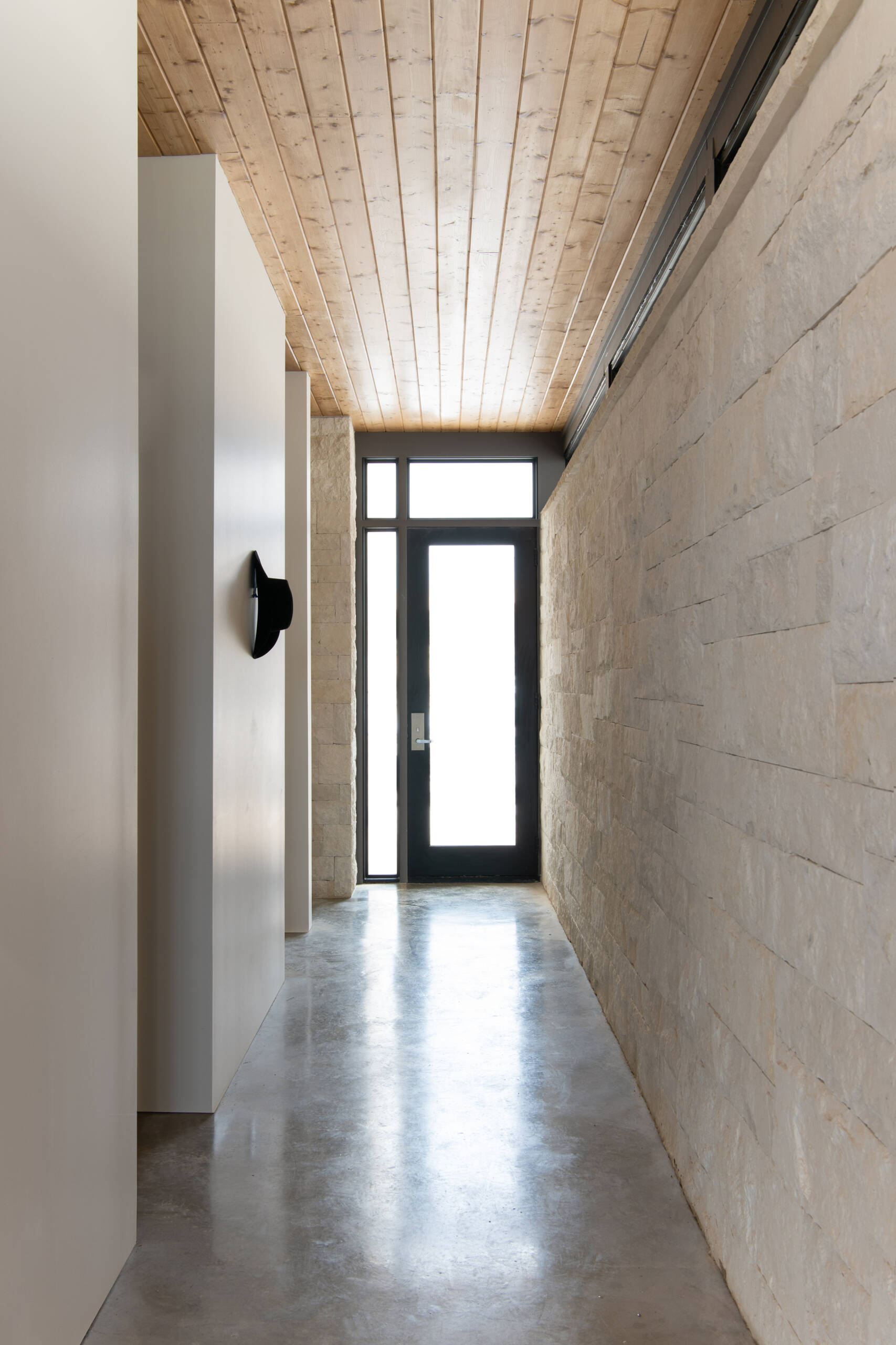 Thick limestone walls and stone-framed doorways give these contemporary Texas homes distinctive entryways and hallways.