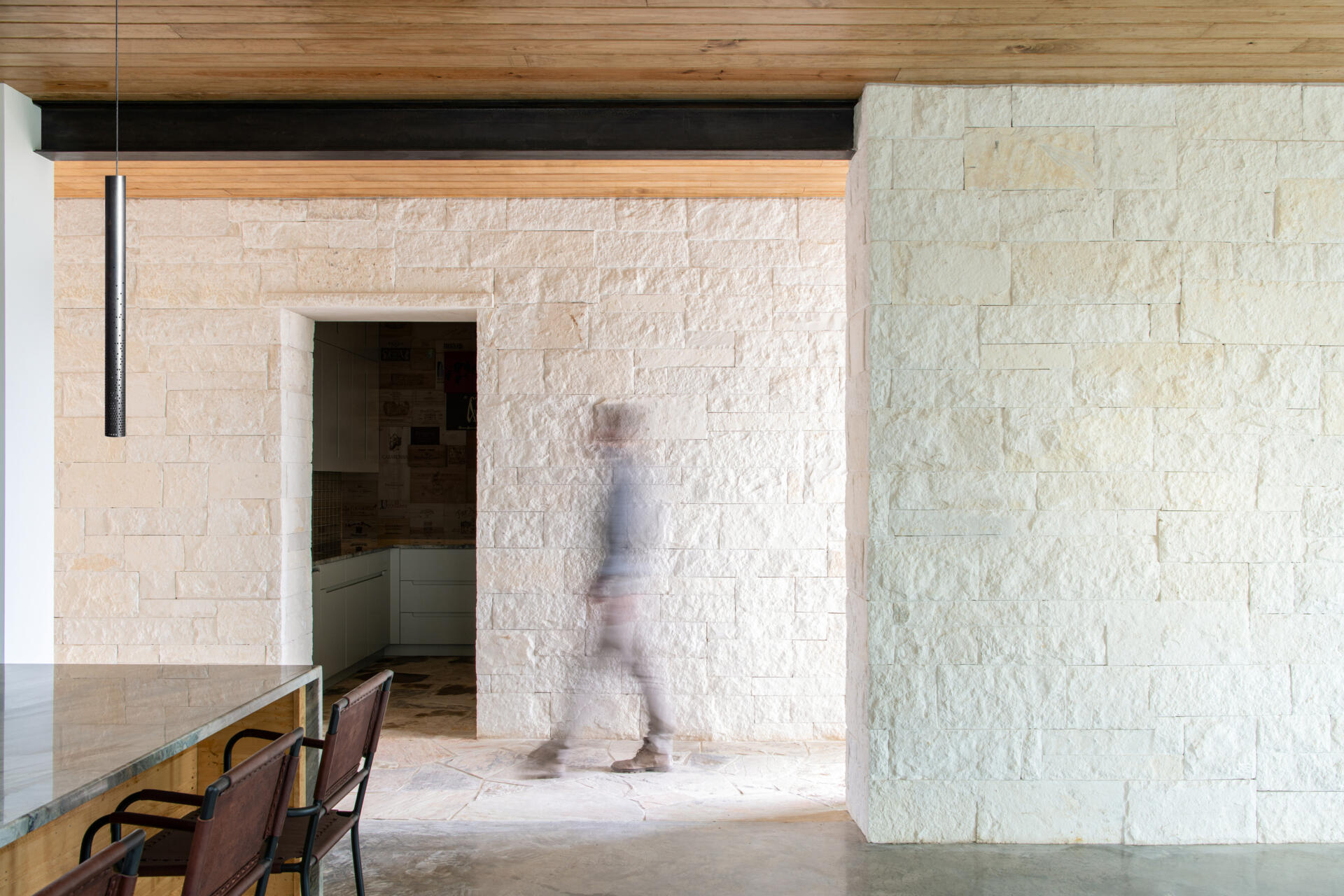 Thick limestone walls and stone-framed doorways give these contemporary Texas homes distinctive entryways and hallways.