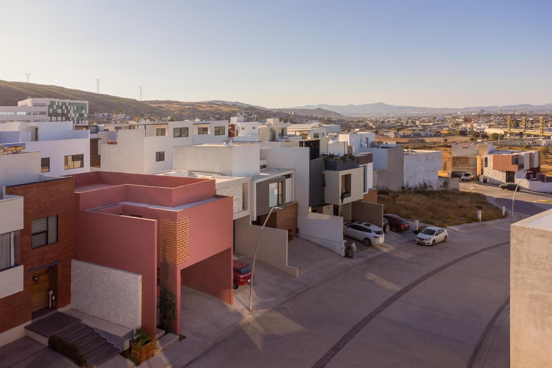 Explore Casa Cardona, a modern pink house in San Luis Potosí, Mexico, featuring geometric architecture, perforated brick screens, textured exterior walls, and desert-inspired colors.