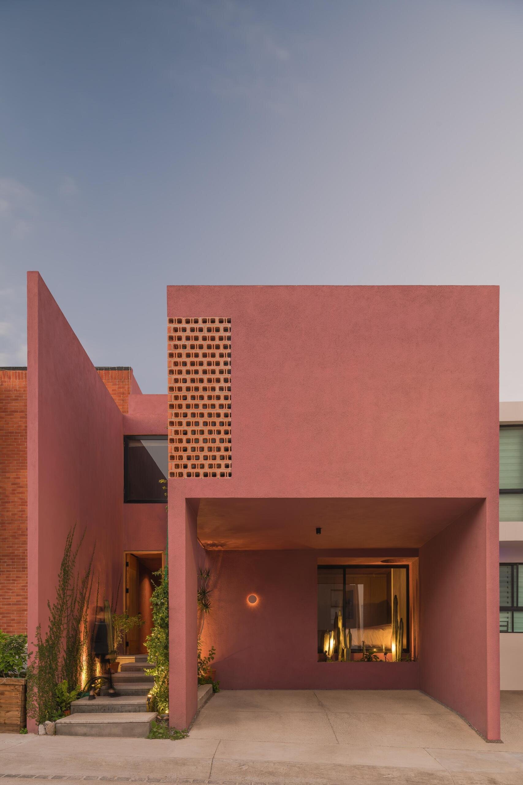 Explore Casa Cardona, a modern pink house in San Luis Potosí, Mexico, featuring geometric architecture, perforated brick screens, textured exterior walls, and desert-inspired colors.