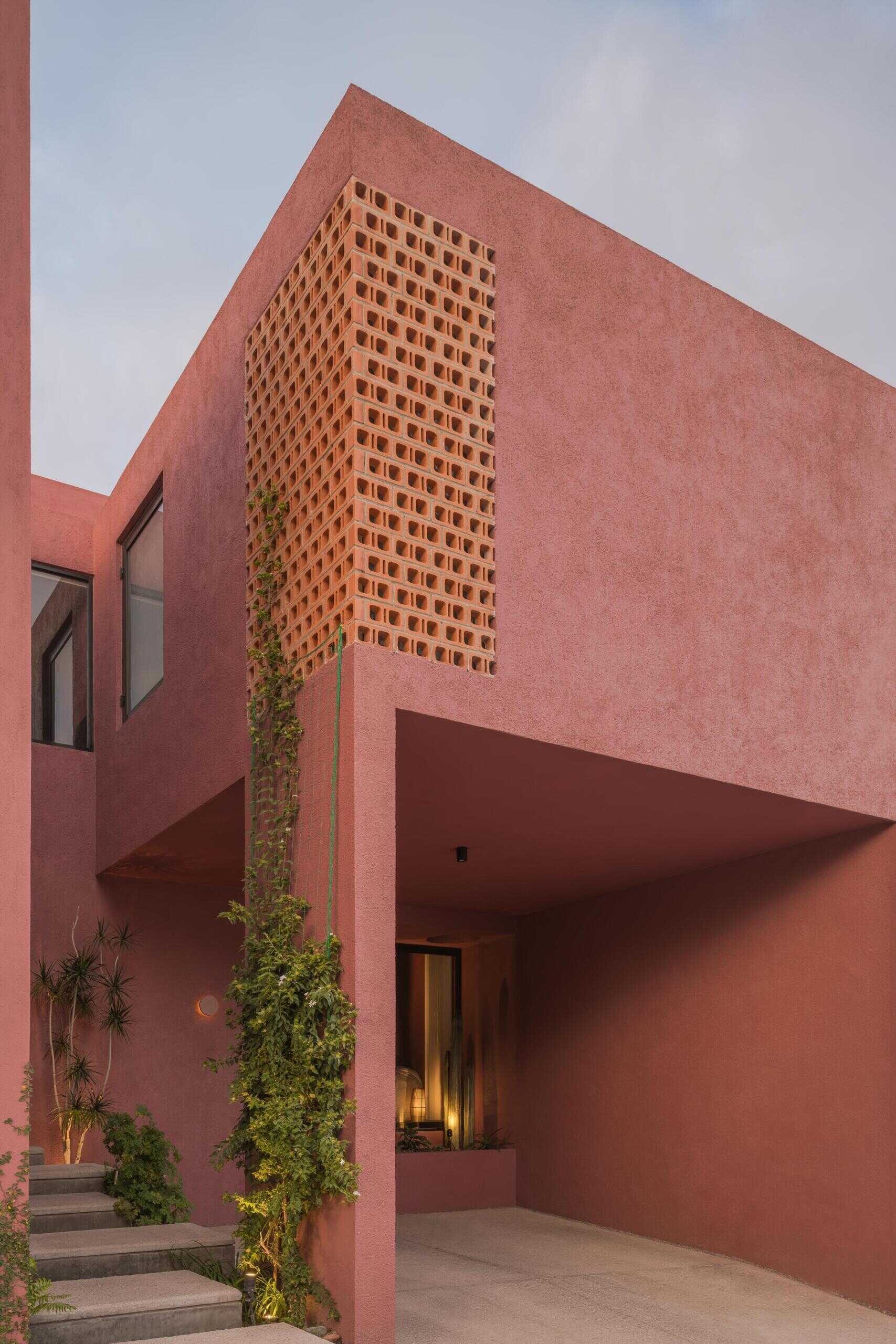 Explore Casa Cardona, a modern pink house in San Luis Potosí, Mexico, featuring geometric architecture, perforated brick screens, textured exterior walls, and desert-inspired colors.
