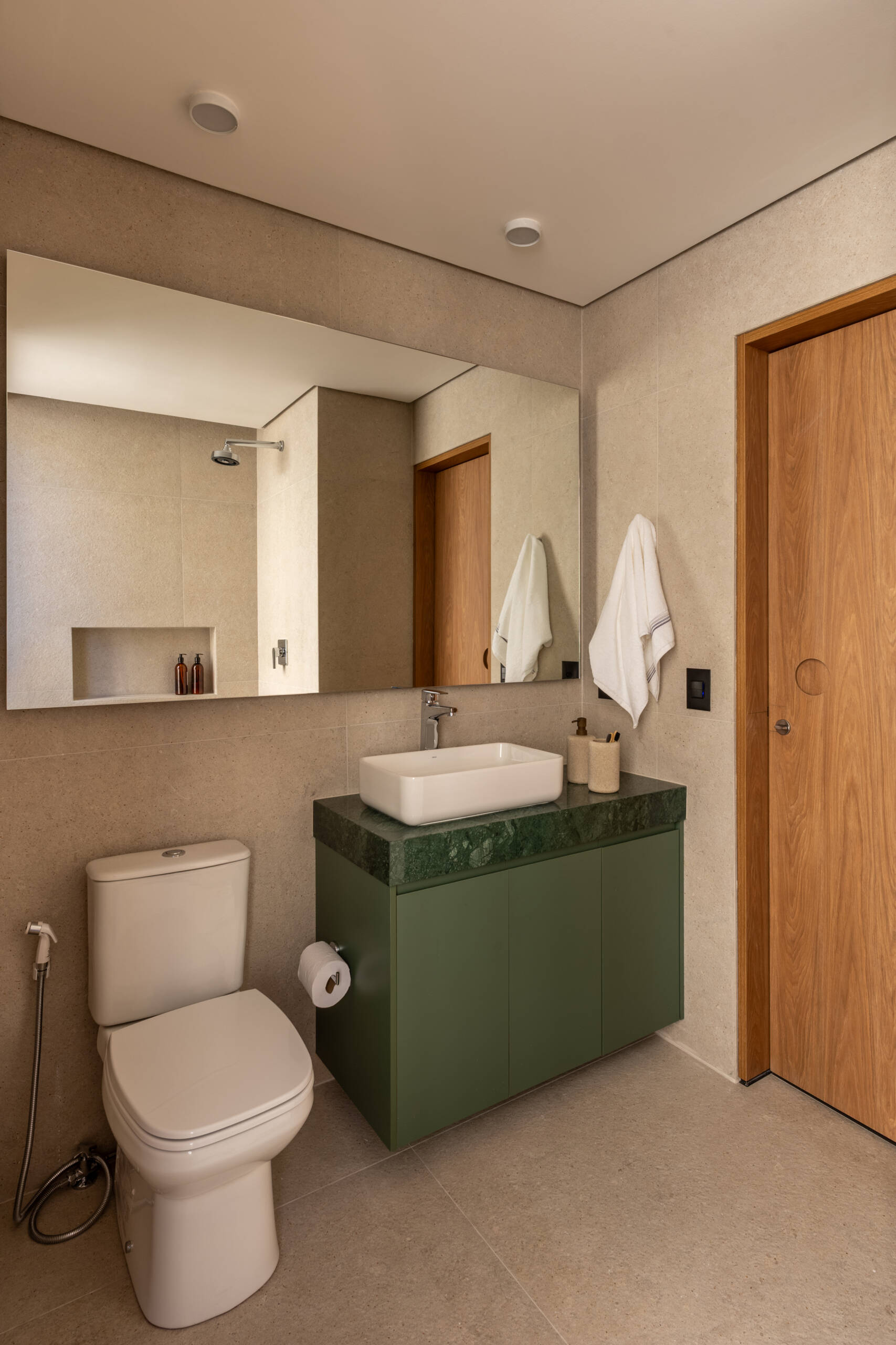 Explore the space-saving layout of Casa M38, a small prefab home with an open kitchen and living room, an integrated dining table, a private bedroom with a workspace, and a bathroom.