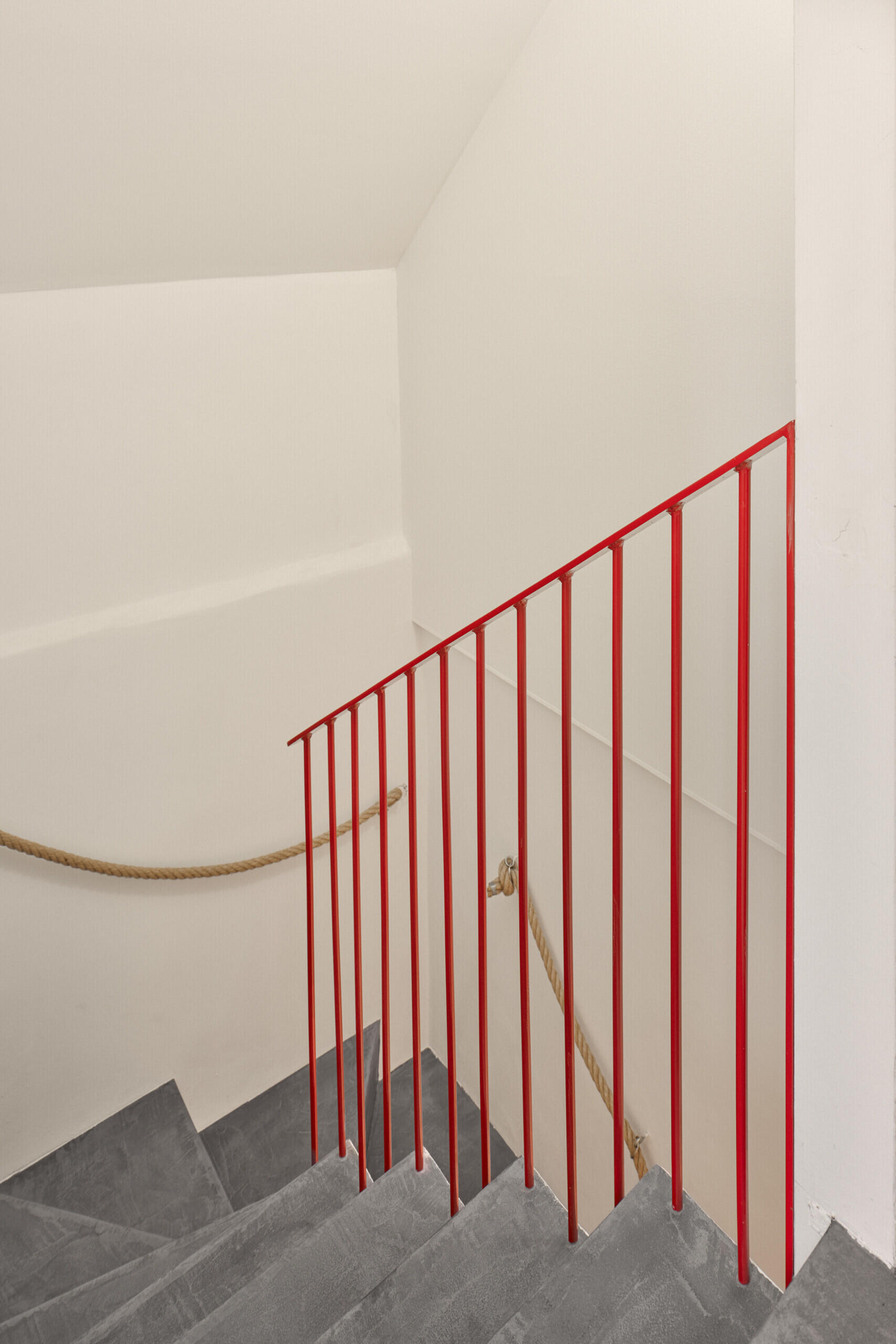 The basement of this renovated home in Ne?ín, Czech Republic, was largely left unchanged, with a compact staircase providing the transition from the extensively reworked ground floor above.